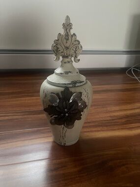 Source Unknown Cream Distressed Urn with Dark Metal Flower Accent